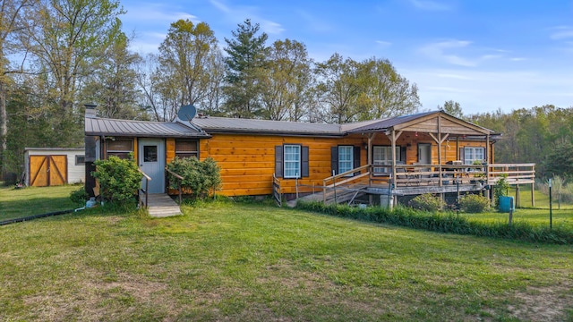 105 Massingale Rd, Tellico Plains, TN 37385 - back of house with a lawn, a chimney, covered porch, and metal roof