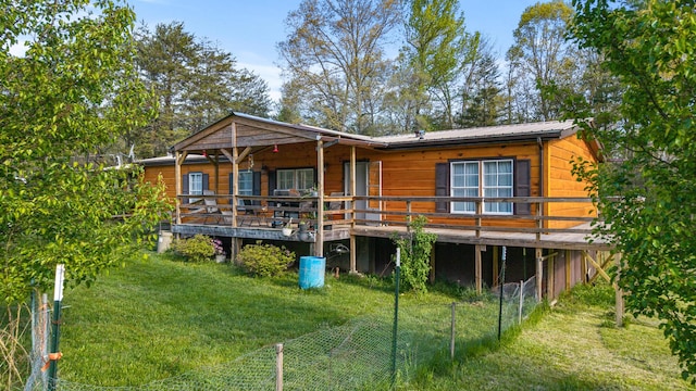 105 Massingale Rd, Tellico Plains, TN 37385 - rear view of house featuring a deck, fence, metal roof, and a lawn
