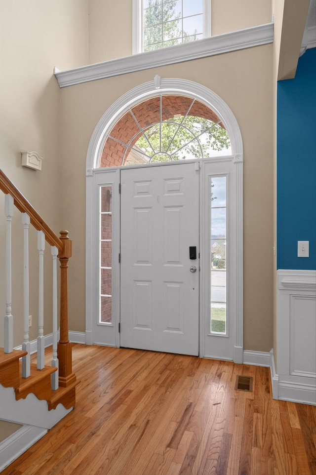6970 Bullock Way, Hixson, TN 37343 - entrance foyer featuring light wood-style flooring, stairway, and wainscoting