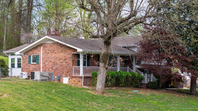 7004 Lystra Rd, Harrison, TN 37341 - view of side of property with a yard, brick siding, covered porch, and roof with shingles