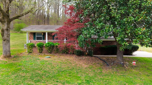 7004 Lystra Rd, Harrison, TN 37341 - view of front of house featuring a porch, a front yard, and brick siding