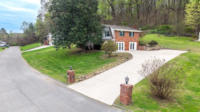 7004 Lystra Rd, Harrison, TN 37341 - view of front of property with concrete driveway, brick siding, and french doors
