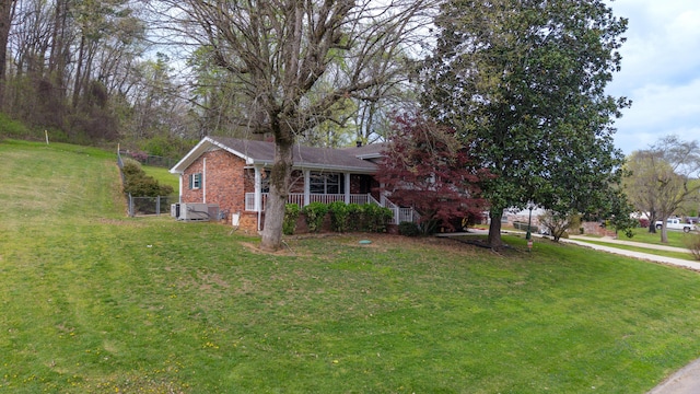 7004 Lystra Rd, Harrison, TN 37341 - view of front of house featuring a front lawn, brick siding, and a porch