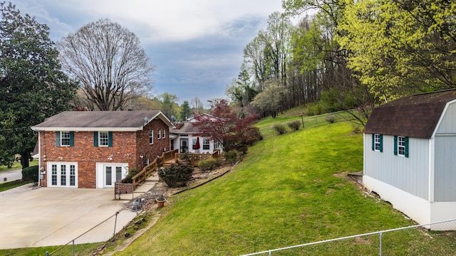 7004 Lystra Rd, Harrison, TN 37341 - view of yard with french doors, a patio, and a storage unit