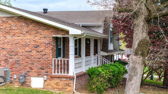 7004 Lystra Rd, Harrison, TN 37341 - view of side of home featuring brick siding, a shingled roof, and a porch