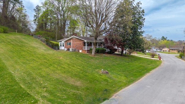 7004 Lystra Rd, Harrison, TN 37341 - view of side of home featuring brick siding, a lawn, and a chimney