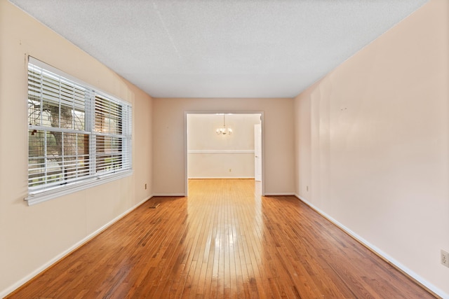 7004 Lystra Rd, Harrison, TN 37341 - unfurnished room with hardwood / wood-style flooring and a chandelier