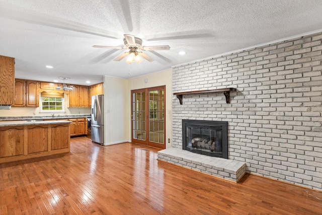 7004 Lystra Rd, Harrison, TN 37341 - kitchen with stainless steel fridge with ice dispenser, a textured ceiling, brown cabinets, light wood finished floors, and ceiling fan