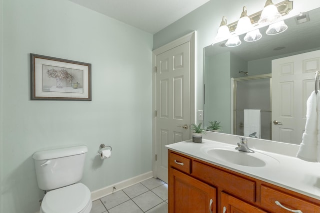 bathroom with tile patterned floors, a shower with door, toilet, vanity, and baseboards
