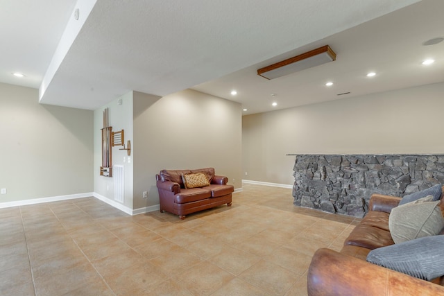 living room featuring light tile patterned floors, baseboards, and recessed lighting