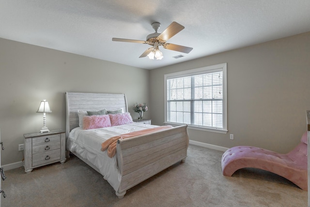 bedroom featuring ceiling fan, visible vents, baseboards, and light carpet