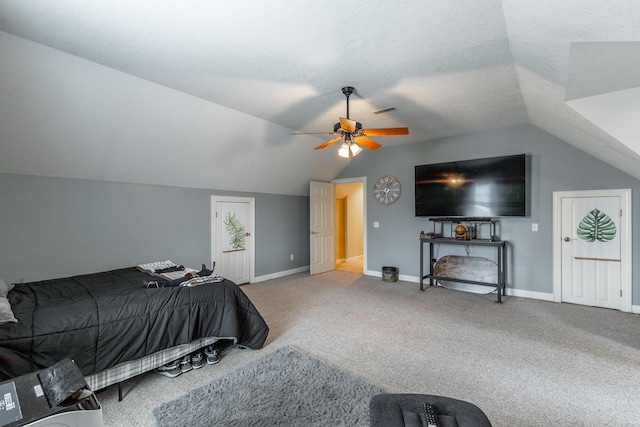carpeted bedroom featuring baseboards, vaulted ceiling, visible vents, and a ceiling fan
