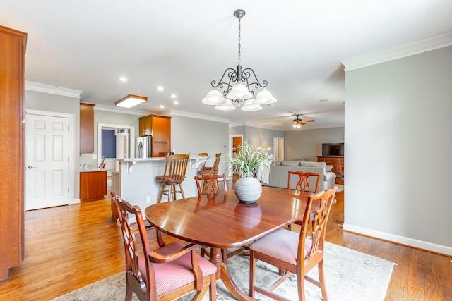 dining area with light wood finished floors, baseboards, recessed lighting, ceiling fan with notable chandelier, and crown molding