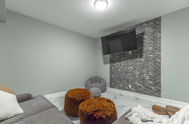 sitting room featuring baseboards and marble finish floor