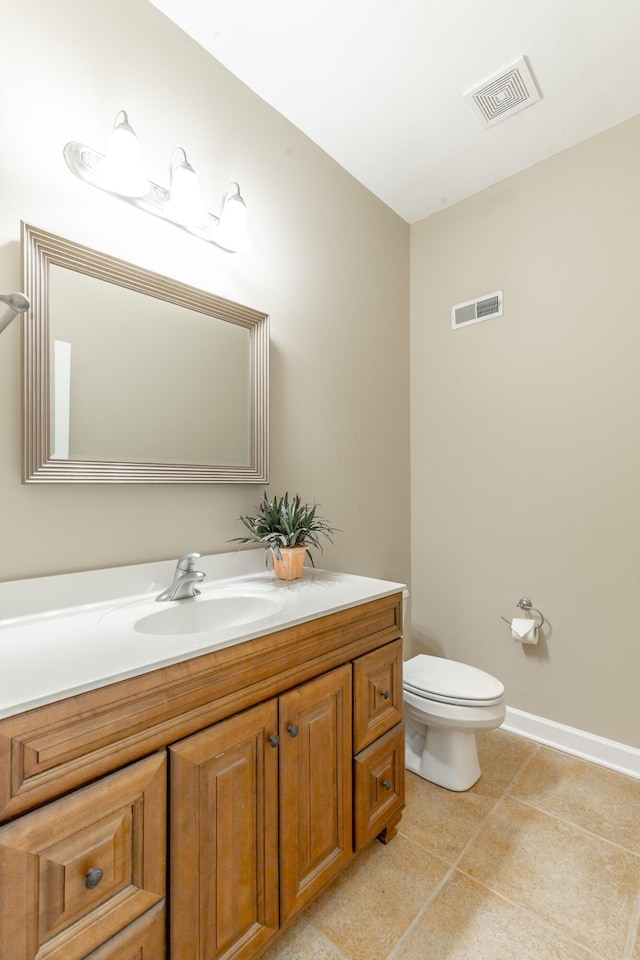 half bathroom with tile patterned flooring, toilet, vanity, and visible vents