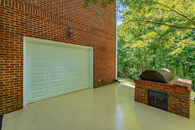 garage featuring concrete driveway