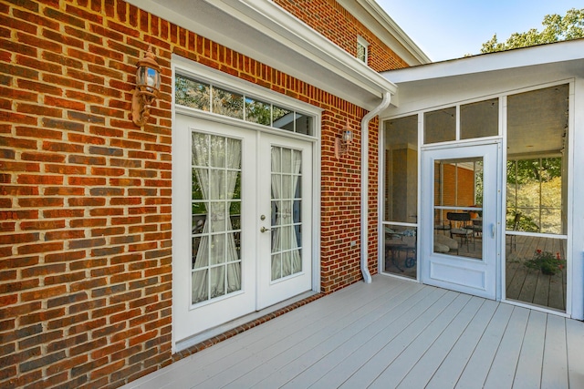 deck featuring french doors and a sunroom