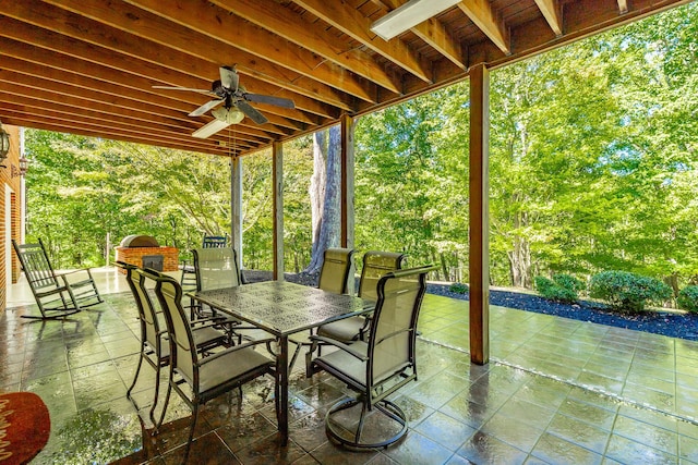 view of patio with outdoor dining space and a ceiling fan