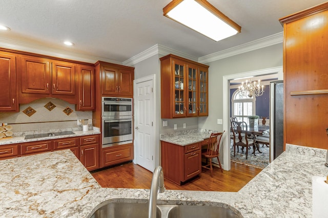 kitchen featuring a sink, stainless steel double oven, black electric cooktop, ornamental molding, and dark wood-style floors