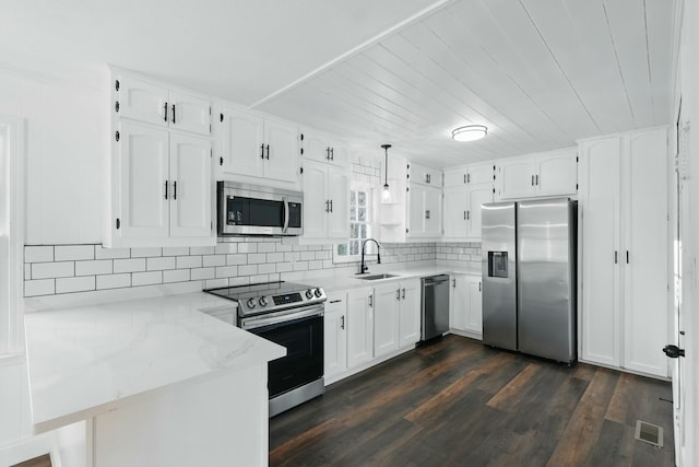 kitchen with stainless steel appliances, a peninsula, a sink, visible vents, and white cabinetry
