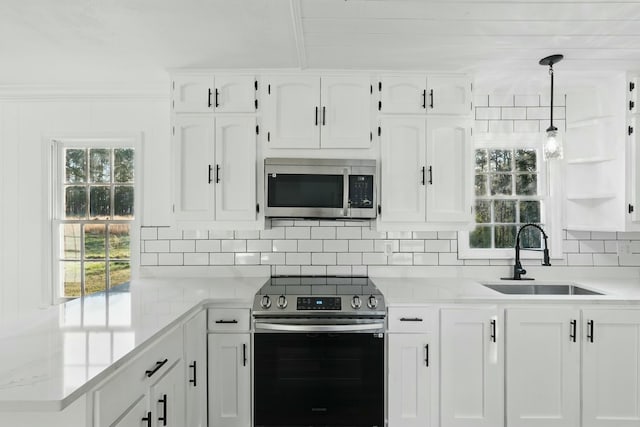 kitchen with light countertops, a sink, white cabinetry, and appliances with stainless steel finishes