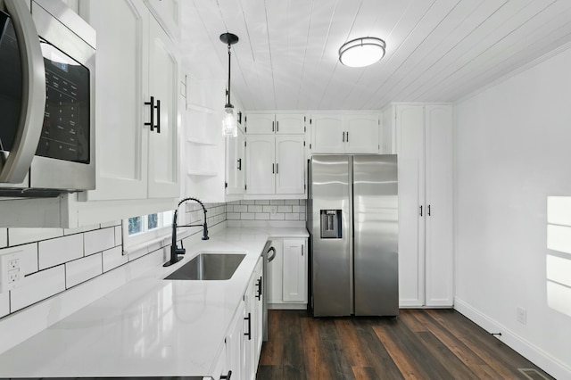 kitchen with a sink, white cabinetry, appliances with stainless steel finishes, and dark wood-style flooring