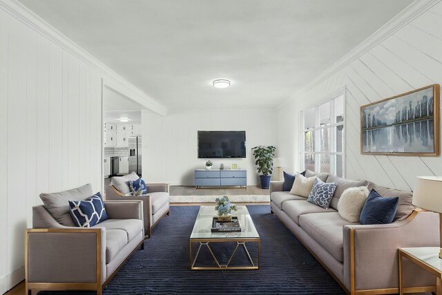 living area featuring ornamental molding and wooden walls