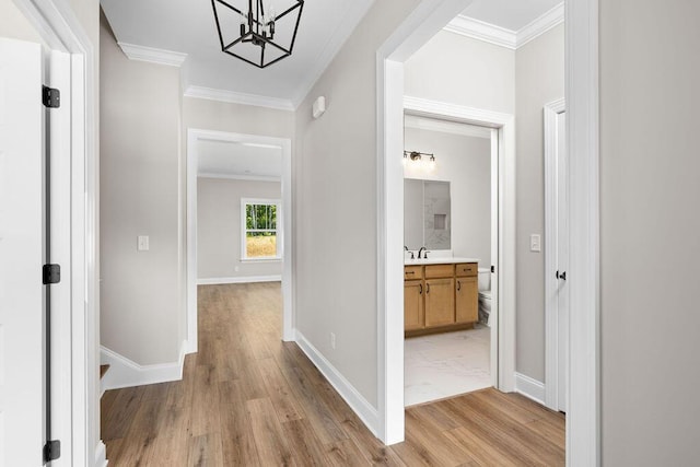 11819 Herons Haven Dr # 102, Soddy Daisy, TN 37379 - corridor featuring crown molding, light wood finished floors, a chandelier, and baseboards