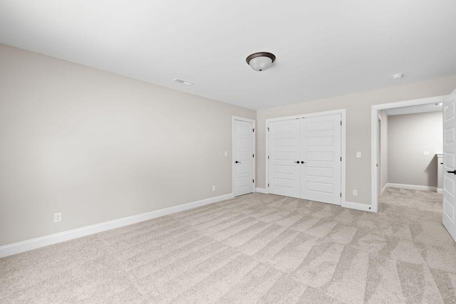 11819 Herons Haven Dr # 102, Soddy Daisy, TN 37379 - unfurnished bedroom with a closet, light carpet, and baseboards