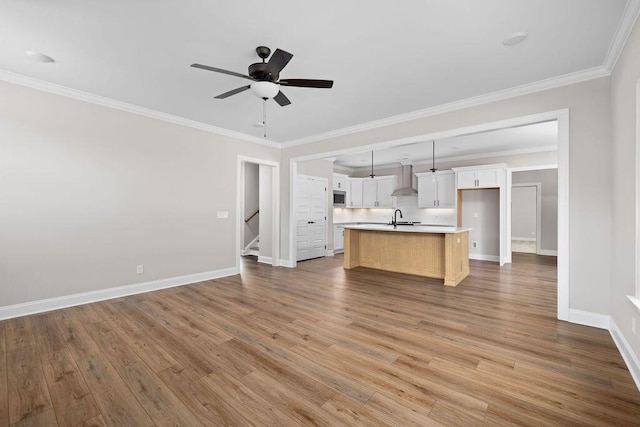 11819 Herons Haven Dr # 102, Soddy Daisy, TN 37379 - kitchen featuring a sink, open floor plan, an island with sink, baseboards, and light countertops