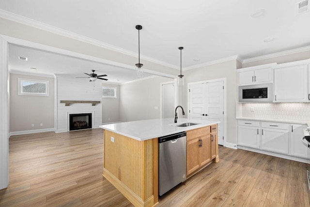 11819 Herons Haven Dr # 102, Soddy Daisy, TN 37379 - kitchen with stainless steel dishwasher, a sink, built in microwave, light wood finished floors, and ornamental molding