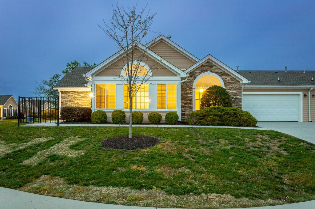 2527 Baskette Way, Chattanooga, TN 37421 - view of front of property featuring stone siding, a garage, concrete driveway, and a front yard