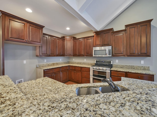 7954 Burgundy Cir Unit 91, Chattanooga, TN 37421 - kitchen with lofted ceiling with beams, recessed lighting, appliances with stainless steel finishes, a sink, and light stone counters