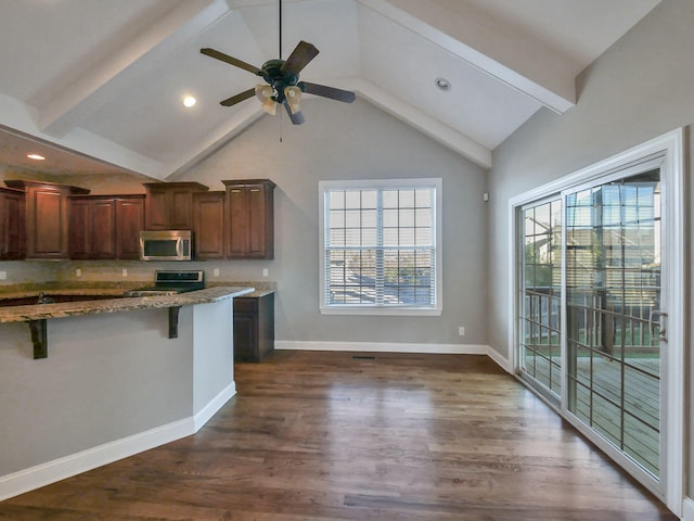7954 Burgundy Cir Unit 91, Chattanooga, TN 37421 - kitchen featuring light stone counters, beam ceiling, a kitchen bar, appliances with stainless steel finishes, and dark wood finished floors