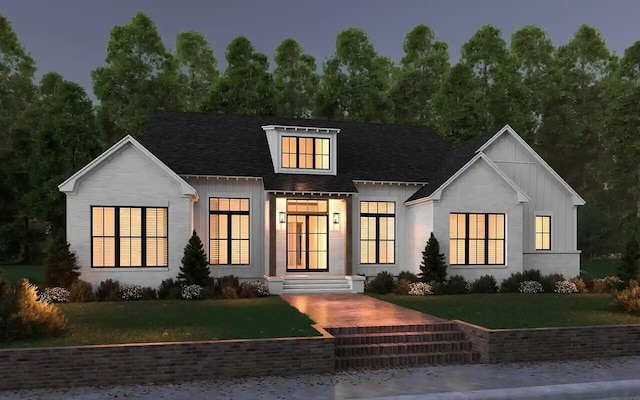 modern inspired farmhouse featuring board and batten siding, a front lawn, and roof with shingles
