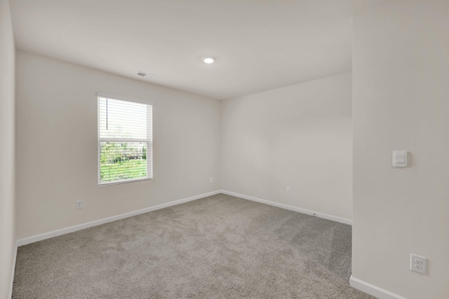 carpeted empty room with baseboards and visible vents