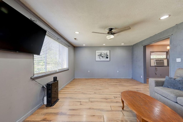 934 Hulana St, Rossville, GA 30741 - living room with light wood-type flooring, baseboards, a textured ceiling, visible vents, and a ceiling fan