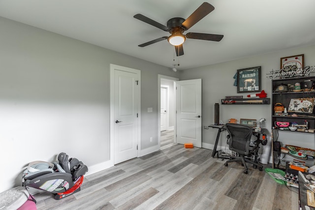 home office with baseboards, a ceiling fan, and wood finished floors