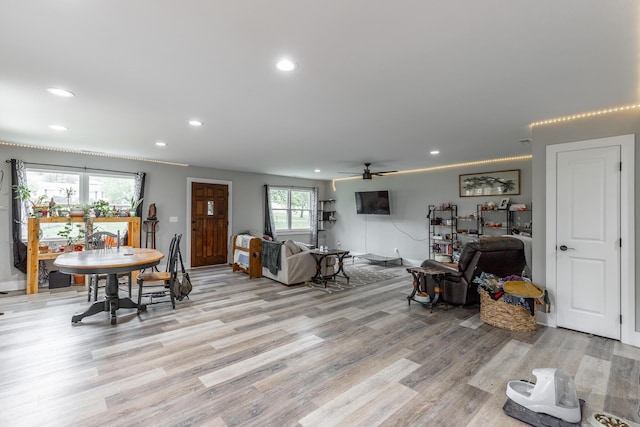 living room featuring light wood-type flooring, recessed lighting, baseboards, and a ceiling fan