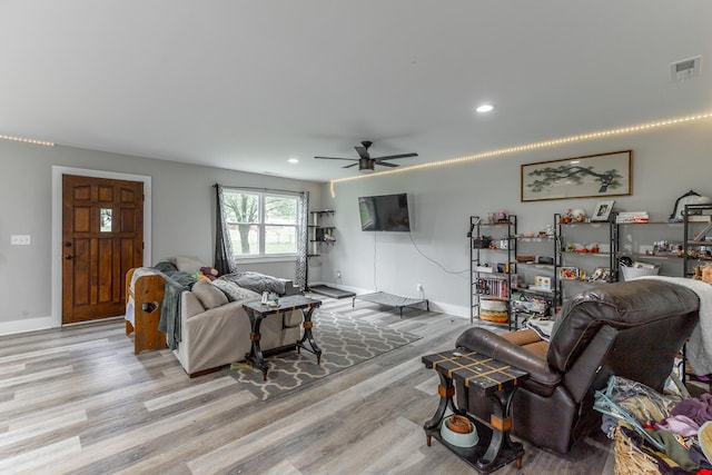 living area with light wood-style floors, recessed lighting, and visible vents