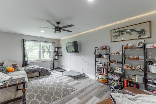 living area featuring recessed lighting, ceiling fan, baseboards, and wood finished floors