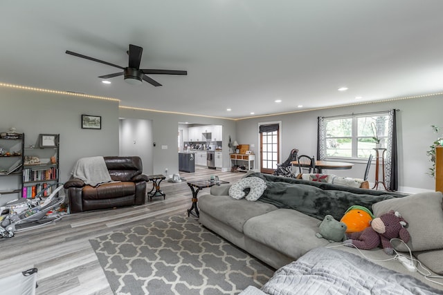 living room featuring recessed lighting, a ceiling fan, and wood finished floors