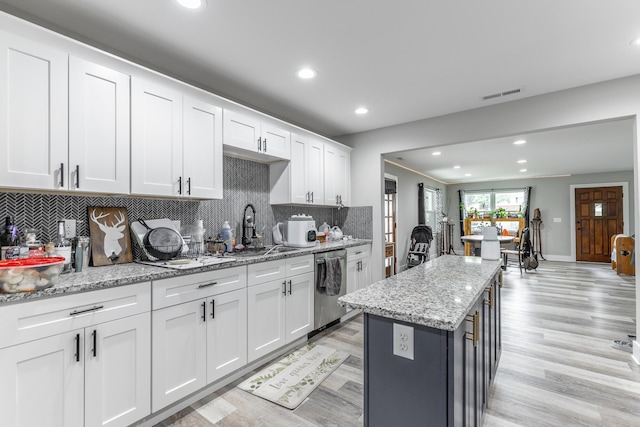 kitchen with tasteful backsplash, recessed lighting, visible vents, stainless steel dishwasher, and a sink