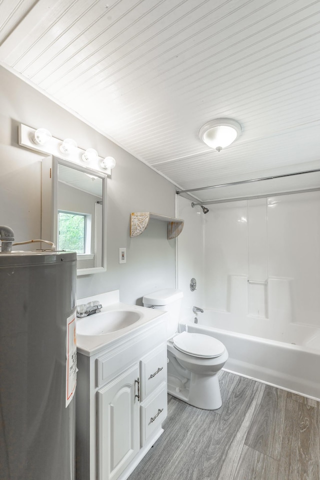 bathroom featuring toilet, electric water heater, bathtub / shower combination, vanity, and wood finished floors