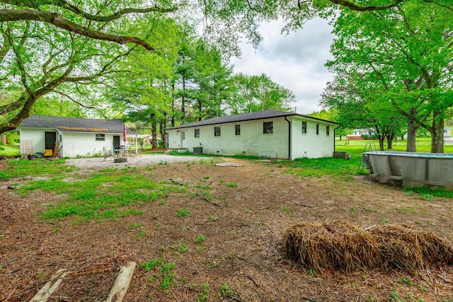 back of property with an outdoor structure