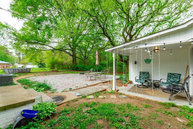 view of yard featuring a patio and central AC unit