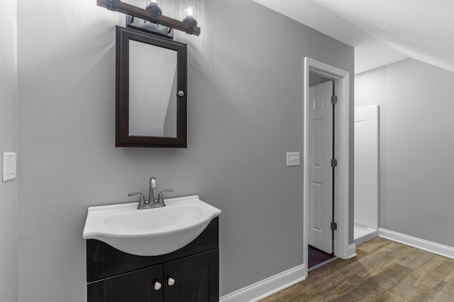 204 Lake Haven Dr, Soddy Daisy, TN 37379 - bathroom featuring wood finished floors, vanity, baseboards, and vaulted ceiling