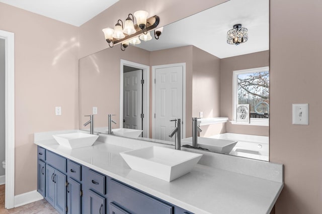 204 Lake Haven Dr, Soddy Daisy, TN 37379 - bathroom featuring double vanity, a chandelier, and baseboards
