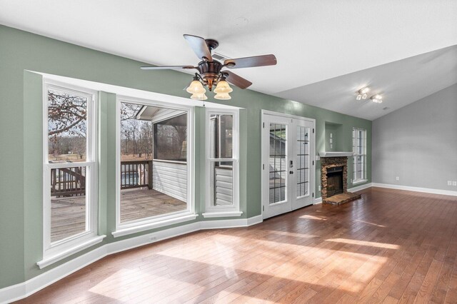 204 Lake Haven Dr, Soddy Daisy, TN 37379 - unfurnished living room featuring hardwood / wood-style floors, baseboards, a fireplace, a ceiling fan, and vaulted ceiling
