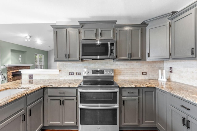 204 Lake Haven Dr, Soddy Daisy, TN 37379 - kitchen featuring stainless steel appliances, gray cabinets, a sink, and tasteful backsplash